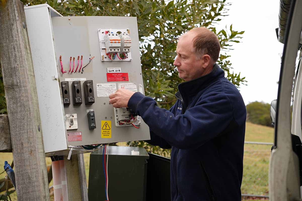 Chris of ProSwitch Electrical inspects an outdoor electrical switchboard/control panel in Tasman, New Zealand
